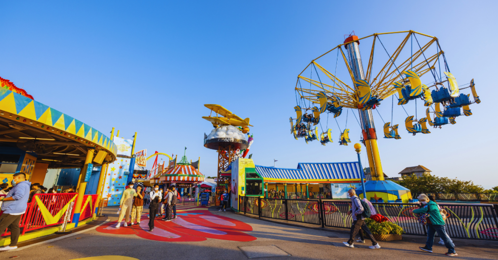 "Group of young adults enjoying a vibrant sunset at Orlando,Beyond the Theme Parks, one of the best places in Florida for young adults to vacation, showing a lively boardwalk scene with palm trees and beach activities."