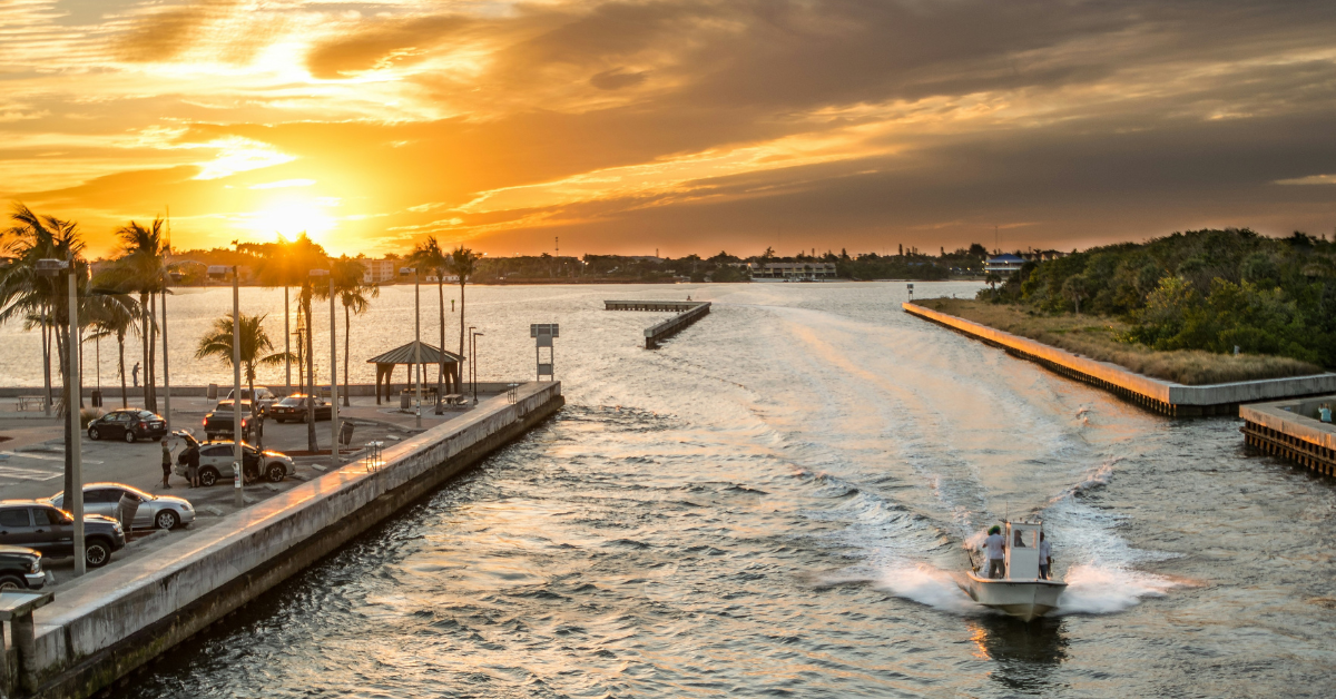 "Group of young adults enjoying a vibrant sunset at Miami Beach, one of the best places in Florida for young adults to vacation, showing a lively boardwalk scene with palm trees and beach activities."